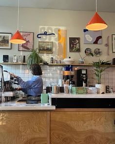 a woman sitting at a counter in a coffee shop