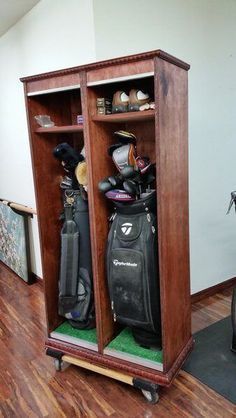 a wooden cabinet filled with golf gear on top of a hard wood floored floor