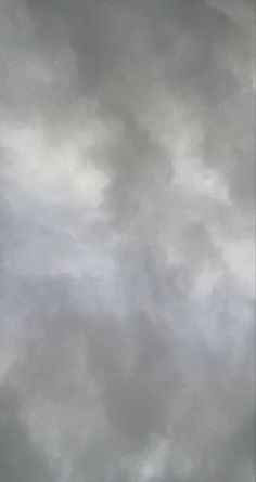 an airplane is flying in the cloudy sky