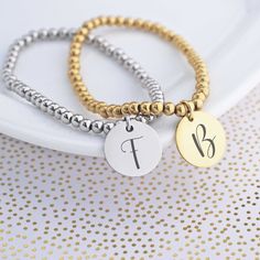 This adorable stretch bracelet makes the perfect gift for your bridesmaids, mother in law or mom. The listing is for 1 stretch bracelet with a charm. The charm measures 5/8 inch and is engraved with a single initial. Available in stainless steel and yellow gold plated steel. The bracelet is available in 2 sizes- small/medium and medium/large. S/M fits wrists from 5 - 6 1/2 inches and M/L fits wrists 6-7 1/2 inches. Please let me know the initial for engraving in the text box. Let me know if you Custom Engraved Bracelet, Moms Bracelet, Bracelet Wedding, Personalized Bracelet, Guest Gifts, Bridesmaid Bracelet, Text Box, Personalized Bracelets, Initial Charm