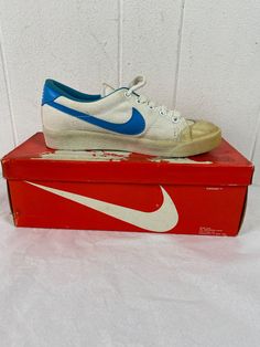 "Women's vintage 1980s white canvas with blue swoosh tennis shoes. Called Lady all court. Size 5 1/2 Actual measurements are: 9 5/8\" toe to heel across the soles 3 1/4\" across the soles widest point (ball of the foot) In excellent unused condition. New in original box. New old stock. The in soles and arch supports are all in good condition. There is some yellowing to the rubber from age, and some yellowing spots on canvas." Retro Low-top Tennis Sneakers, Vintage White Sneakers With Gum Sole, Vintage White Skate Shoes With Rubber Waffle Outsoles, Vintage White Skate Shoes With Rubber Sole, White Vintage Skate Shoes With Rubber Sole, Vintage Sneakers With Perforated Toe Box, Vintage White Low-top Skate Shoes, Vintage White Skate Shoes For Skateboarding, Retro Canvas Skate Shoes With Gum Sole