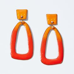 two pairs of orange and yellow earrings on a white background