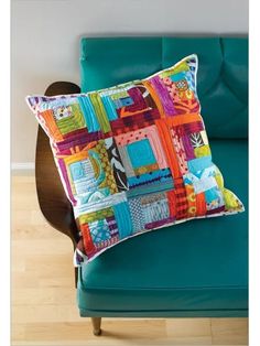 a blue couch with a colorful pillow on it