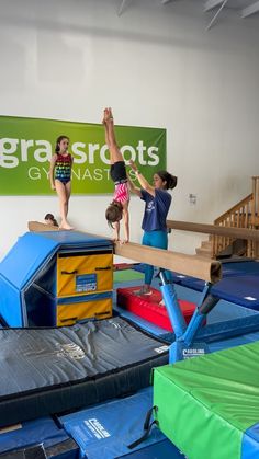 two children are jumping on trampoline in an indoor play area, while another child is standing on top of the trampoline