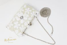 New to our Millennium collection, This beautiful romantic WHITE LACE FLORAL crystal bridal clutch bag is made of very fine quality of fabric and metal and it comes with two chains, one chains length is 15 inches for a shoulder bad 44 inches long cross body bag Detachable chain for your Big day! ► ABOUT YOUR ORDER * All items are neatly packaged in our beautiful jewelry boxes and elegant organza bags. * All items are 100% gift-ready. * Each order comes with a personalized handwritten card and a b White Embroidered Rectangular Evening Bag, Formal White Embroidered Bags, Formal White Embroidered Bag, Formal White Bags With Pearl Embroidery, Formal White Bag With Pearl Embroidery, White Pearl Embroidered Bag For Formal Occasions, White Embroidered Shoulder Bag For Wedding, Embroidered White Shoulder Bag For Wedding, Elegant White Embroidered Shoulder Bag