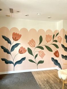 an empty room with flowers painted on the wall