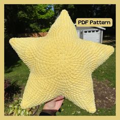 a person holding up a yellow star shaped pillow in their hand with the words pdf pattern above it