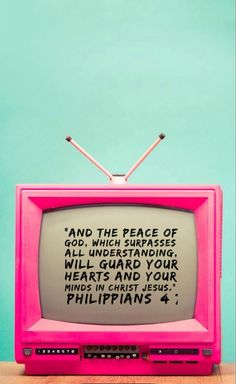 an old pink television with the words and the peace of god on it's screen