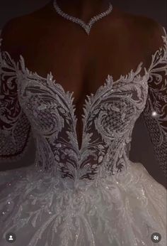 the back of a wedding dress with beading on it