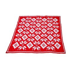 a red and white knitted rug on a white background