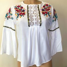 Available By Angela Fashion, Multi Color Floral Embroidered Girls Size Large (Women’s Size Small Fits) White Color Flared Sleeves Buttons Up Never Worn Beautiful And Great Condition Summer Long Sleeve Blouse With Embroidered Hem, Traditional Spring Blouse With Machine Embroidery, Traditional White Peasant Top For Fall, Casual Embroidered Top With Intricate Embroidery For Spring, Bohemian Long Sleeve Tops With Machine Embroidery, Summer Casual Peasant Top With Intricate Embroidery, Spring Cotton Bell Sleeve Blouse, Spring Peasant Top With Embroidered Sleeves, Spring Cotton Blouse With Bell Sleeves