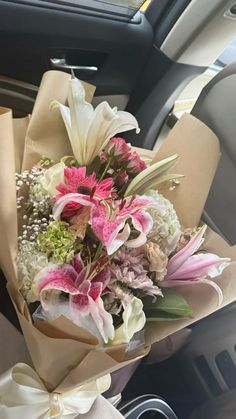 a bouquet of flowers sitting in the back seat of a car