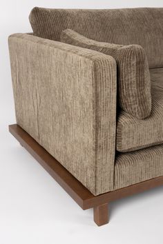 a brown couch sitting on top of a wooden frame