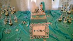 a table topped with frosted cakes covered in frosting and snowflakes