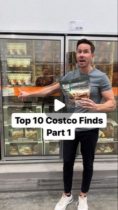 a man standing in front of a store holding up a bag of costco finds