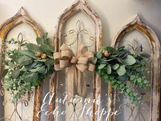 an old window decorated with wreaths and greenery