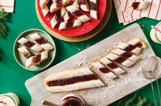 several desserts are arranged on a green table