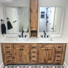 a bathroom with double sinks and mirrors in it's center, surrounded by black and white floor tiles