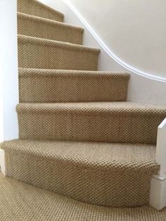 a carpeted staircase leading up to the second floor