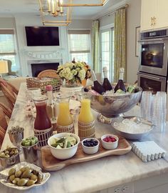 a table filled with food and drinks on top of a kitchen counter