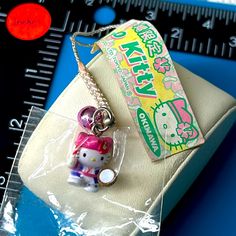 a hello kitty keychain sitting on top of a bag