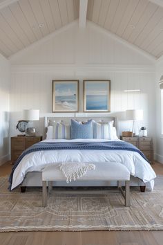 Modern bedroom with vaulted ceiling, ocean-themed wall art, white linens, and blue accents. Wooden nightstands, white lamps, and beige area rug. Summer Room Decor, Coastal Bedroom Decorating, Coastal Room, Living Room Loft, Coastal Bedrooms, Bedroom Renovation, Cottage Bedroom, Coastal Bedroom