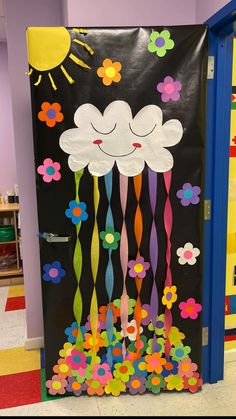 a classroom door decorated with flowers and clouds