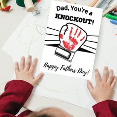 a child holding up a card that says, dad you're a knockout happy father's day