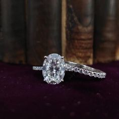 an oval cut diamond ring with side stones