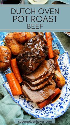 a blue and white plate topped with roast beef, potatoes and carrots next to a bowl of gravy