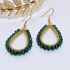 These lovely earrings are handmade using emerald green crystal glass beads. The beads are carefully and individually wrapped around gold teardrop pendants with gold plated, tarnish-resistant wire and hang from hypoallergenic gold 925 sterling silver earring hooks.
The earrings measure approximately 2" long from the top of the earring hook to the bottom teardrop pendant. 
They are perfect to give as a gift or to treat yourself to something special. 
Colors may appear slightly different in images when displayed on your screen. Gold Teardrop Beaded Earrings With Faceted Beads, Elegant Green Beaded Teardrop Earrings, Green Teardrop Beaded Earrings With Wire Wrap, Green Teardrop Beaded Earrings With Wire Wrapped Detail, Green Teardrop Earrings With Faceted Beads, Green Teardrop Wire Wrapped Beaded Earrings, Green Wire Wrapped Teardrop Beaded Earrings, Teardrop Green Crystal Earrings, Handmade Green Teardrop Crystal Earrings