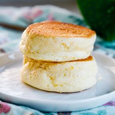 two biscuits sitting on top of a white plate