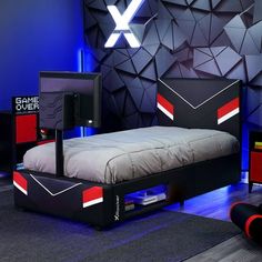 a bed room with a neatly made bed next to a flat screen tv on a stand