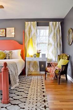 a bedroom with gray walls, orange and white bedding, yellow curtains, and wooden floors