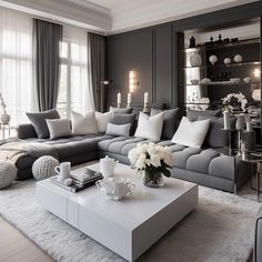 a living room filled with lots of furniture and white flowers on top of a coffee table