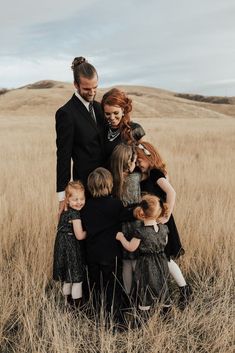 a group of people standing in a field together