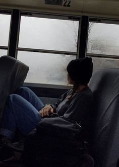 a person sitting on a bus looking out the window