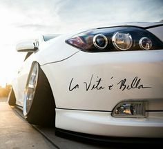 the front end of a white sports car with writing on it's bumpers