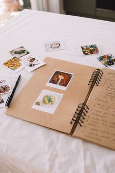 an open book on a bed with pictures and writing in the pages next to it