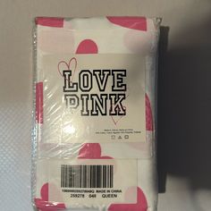 the packaging is wrapped in plastic and has pink hearts on it's back side