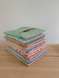 a stack of cloths sitting on top of a wooden table