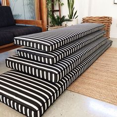 a black and white striped bench sitting on top of a rug