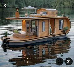 a house boat floating on top of a lake