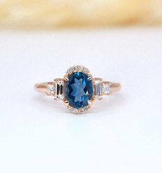 A rare bespoke blue topaz art deco diamond ring for those who looking for excellent peace of artwork. 8 x 6mm oval blue topaz is beautifully covered by princess and baguette cut accent diamonds. The ring can be found in solid 9k/14k/18k rose, yellow, white gold or platinum.  This ring perfectly suits for your wedding, bridal, anniversary occasions. And also, would be a perfect match for Christmas eve gift or any kind of celebration.  ✯✯ Free UK and USA shipping ✯✯ ✯ ✯ No Custom Charges for USA o Ring For Wife, Art Deco Diamond Ring, Deco Diamond Ring, Christmas Eve Gift, Birthday Gift Ring, Art Deco Diamond Rings, Birthday Ring, Diamond Anniversary Rings, Custom Ring