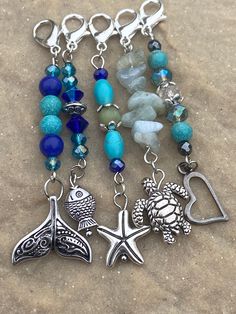 the charms are attached to each other on the beach sand and sea glass bead bracelets