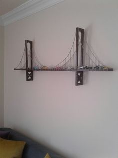 a wall mounted shelf with cars on it