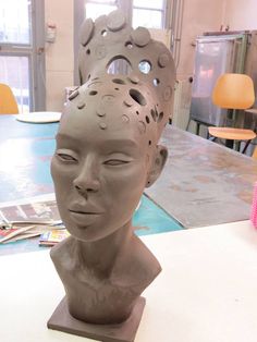 a clay head sitting on top of a table