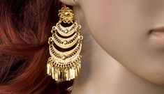 This beautiful Chandelier and very traditional earrings will add to any outfit. They are handcrafted in Filigree  by very talented Artisans in Oaxaca Mexico.  This earrings are Gold-plated 18K, This are the perfect match for any Mexican fiesta, or just a bohemian look.  3 1/2 inches long 1 1/4 wide Due to the nature of the item, there's no returns. Thank you. Temple Jewelry Style Metal Chandelier Earrings, Metal Temple Jewelry Chandelier Earrings, Metal Chandbali Chandelier Earrings With Intricate Design, Celebration Temple Jewelry Chandelier Dangle Earrings, Gold Bohemian Chandelier Earrings With Dangling Beads, Festive Brass Chandelier Earrings For Pierced Ears, Bohemian Jhumkas With Intricate Design, Bohemian Brass Chandbalis For Festive Occasions, Traditional Chandelier Earrings With Dangling Beads For Celebrations