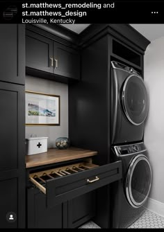 a black laundry room with a washer and dryer