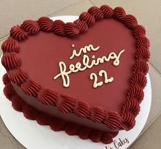 a heart shaped cake with the words i'm feeling 22 written on it